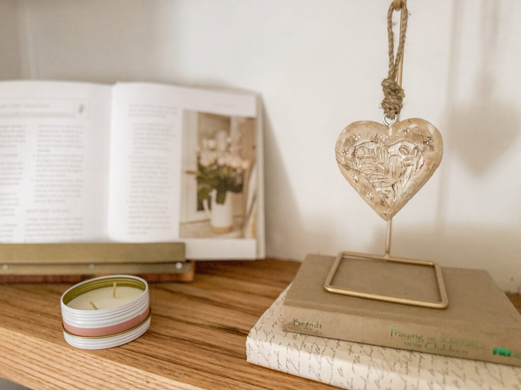 wood floating heart on stand on shelf