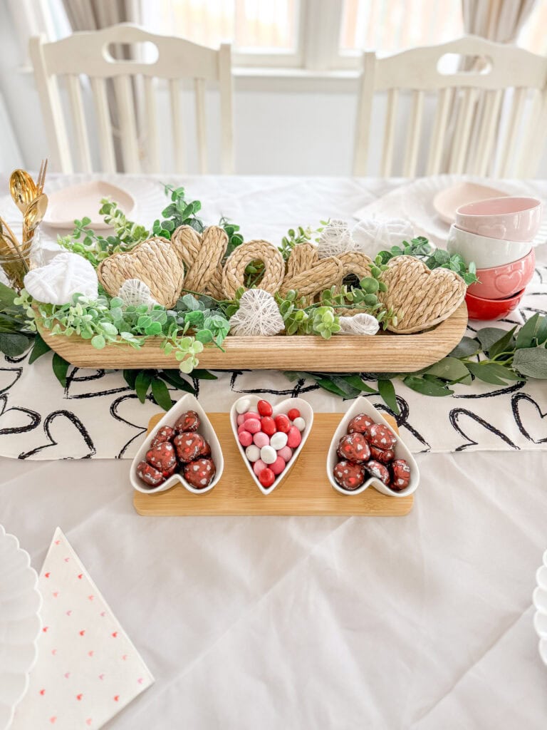 M&ms in heart shaped tray in front of dough bowl for valentine's day table