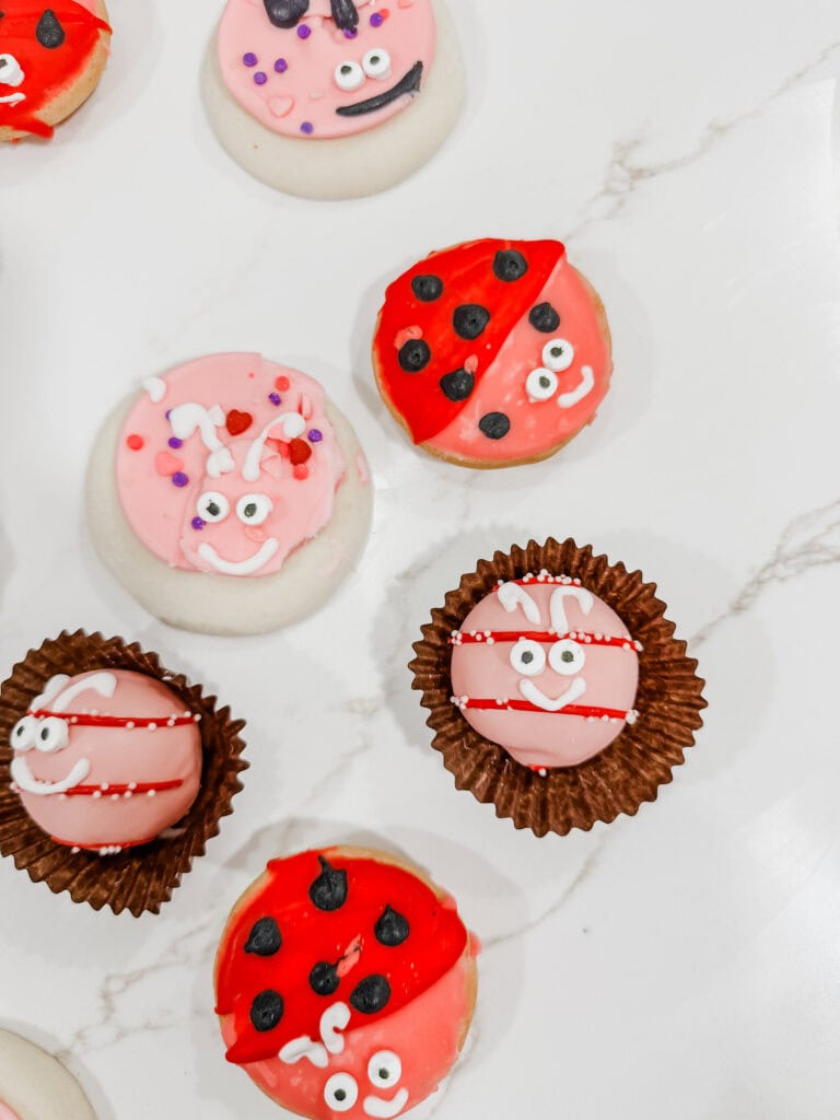 Valentine love bug treats of cookies and cake balls on counter
