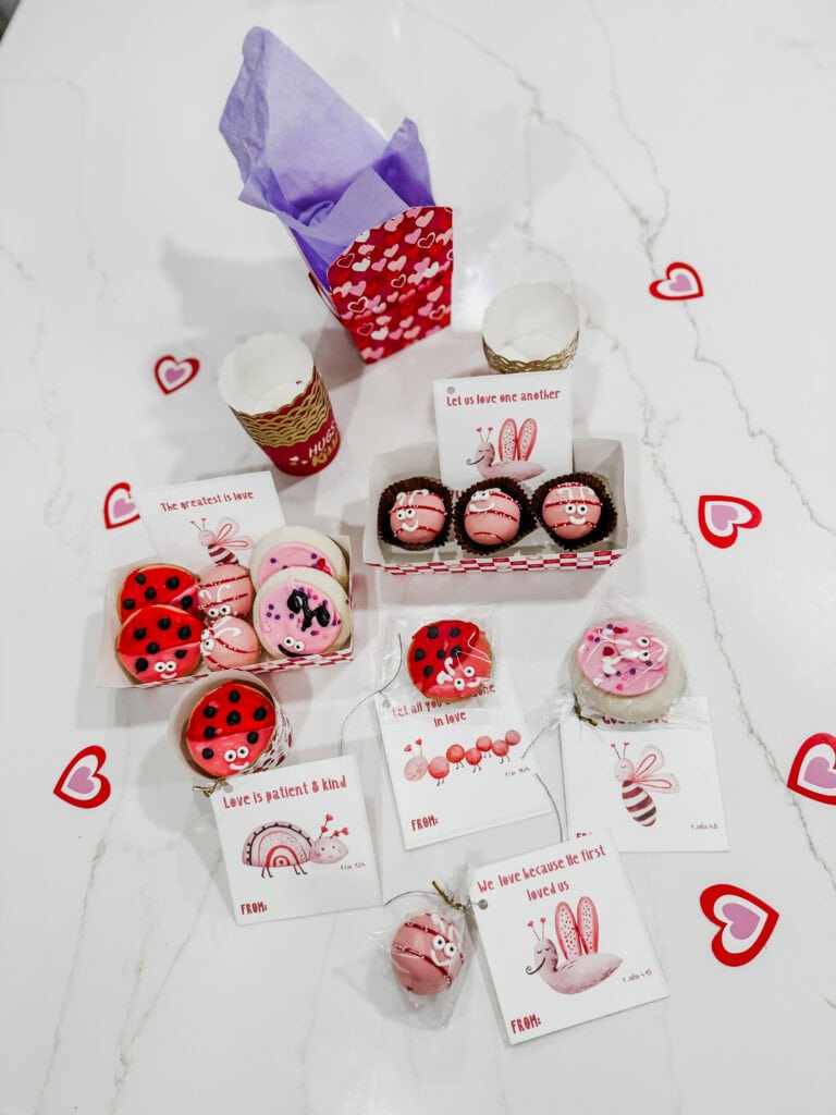love bug cookies and cake balls displayed with cards for Valentine treats and gifts 