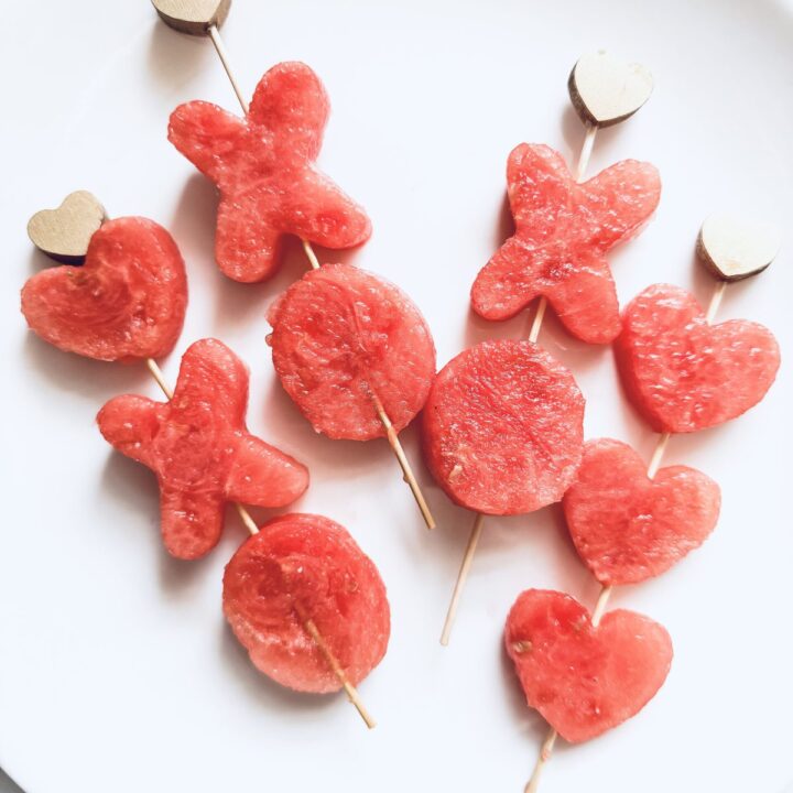Fresh watermelon heart and bowtie shaped fruit skewers, perfect for summer and romantic celebrations, showcasing vibrant, juicy, and nutritious fruit snacks for loved ones.