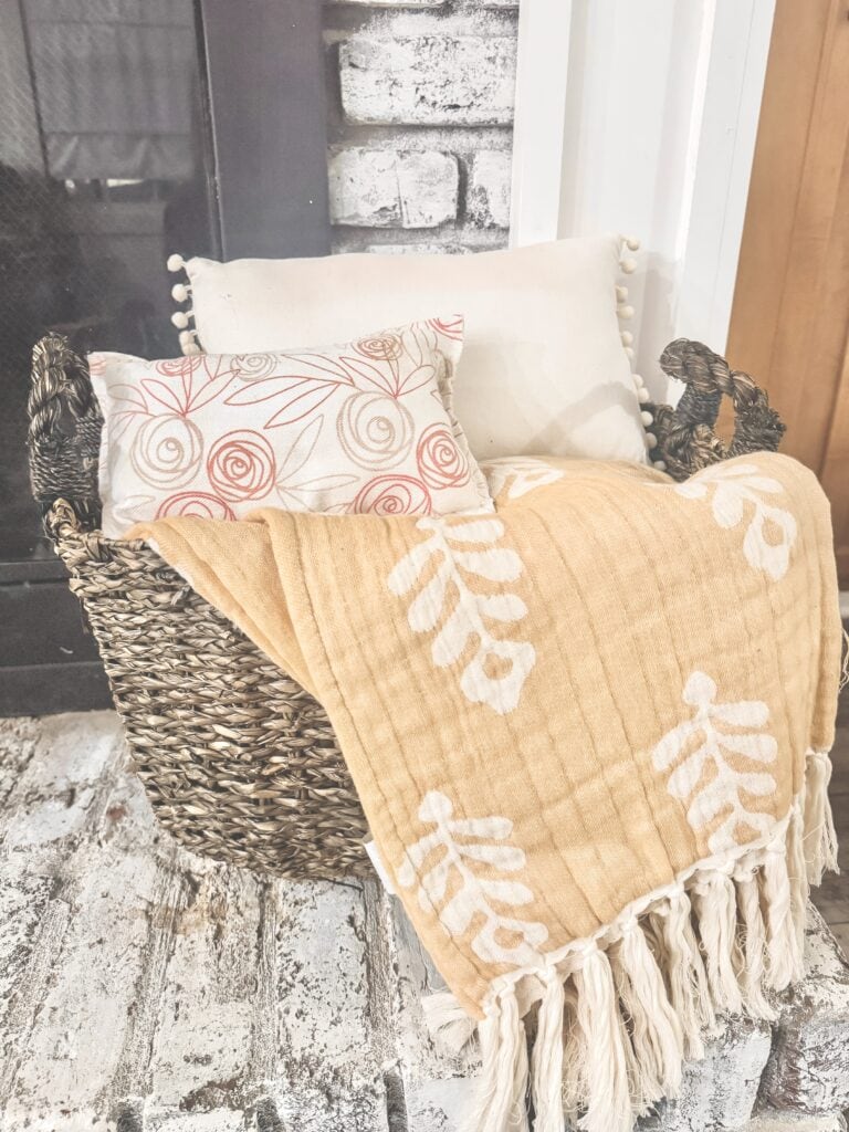 basket of neutral blanket and pink pillows for valentine's day decor
