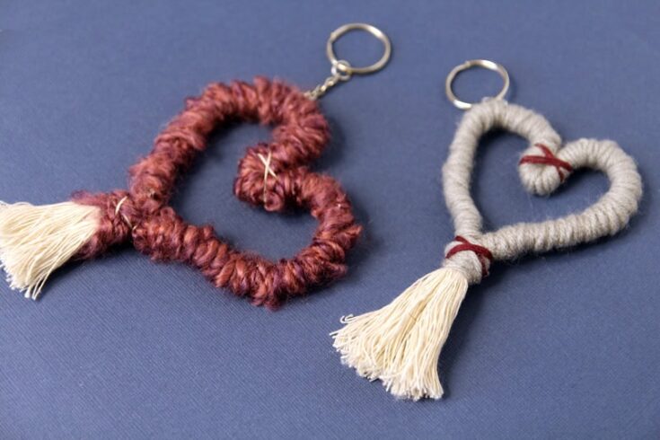 Soft handmade heart-shaped keychains with tassels, crafted from woven yarn in burgundy and grey, perfect for personalized gifts and heartfelt keepsakes.