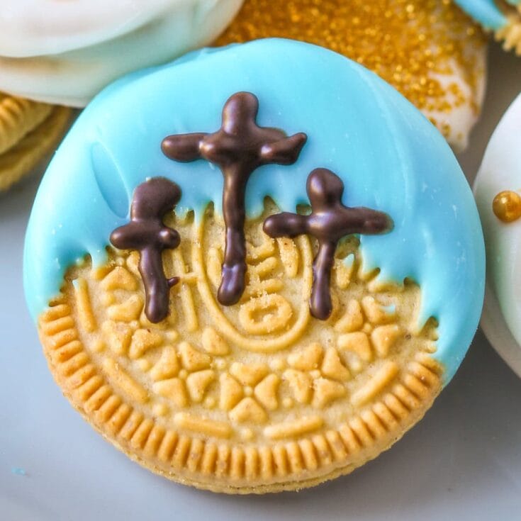 Delicate Christian cross sugar cookie decorated with vibrant blue icing and chocolate crosses, inspired by religious themes and faith-based designs. Perfect for religious celebrations and Christian holidays.