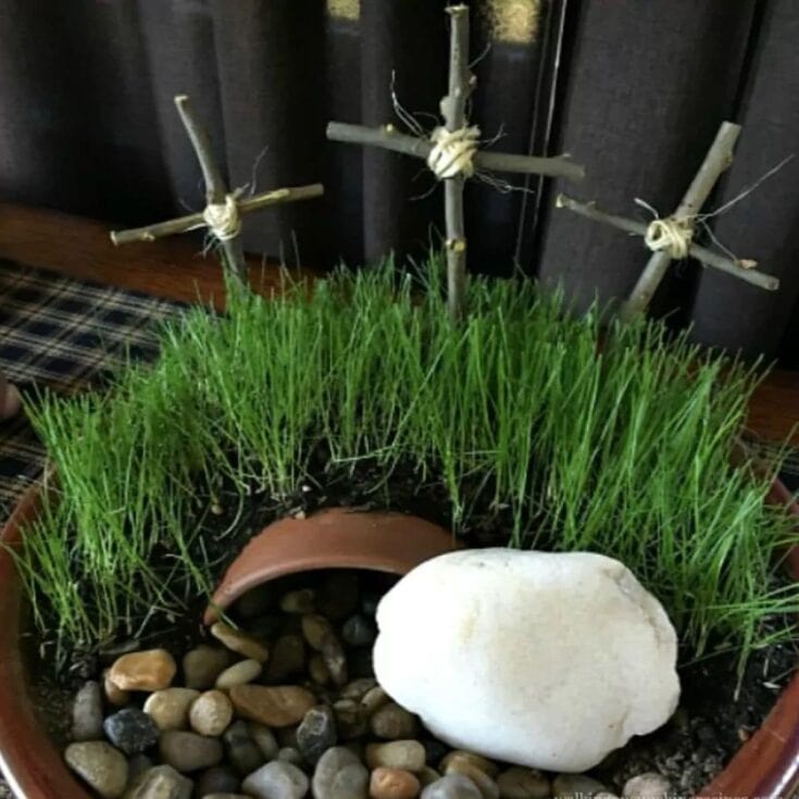 Gourds with cross and grass in flower pot, spiritual garden decor, handmade religious symbols, unique outdoor religious accents, faith-inspired garden arrangement.