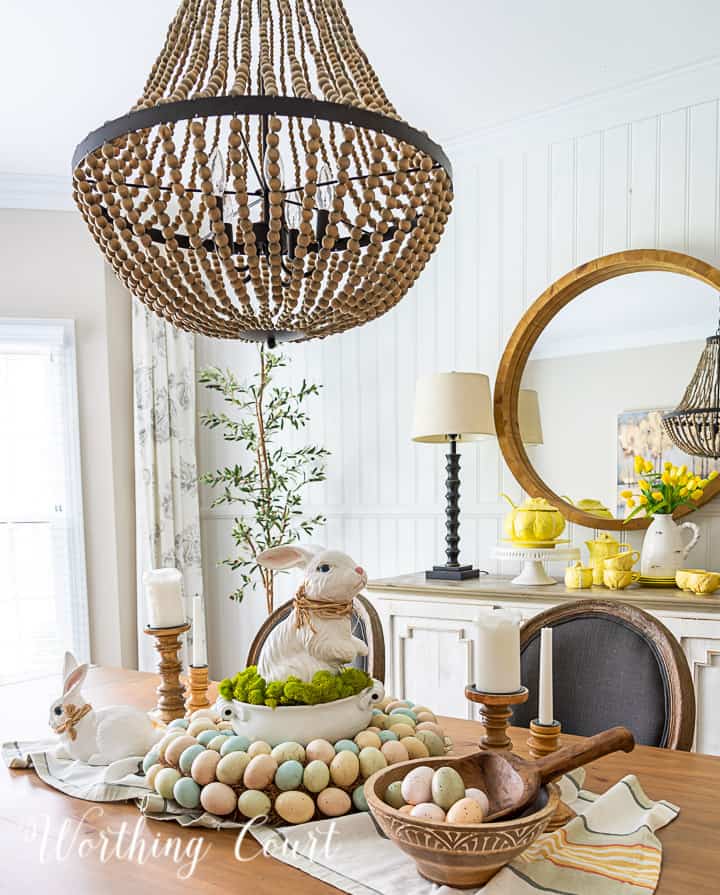 Beaded chandelier, Easter decor, spring table centerpiece, whimsical bunny, pastel eggs, farmhouse dining room, spring table setting, holiday decor, rustic charm, festive table arrangement.