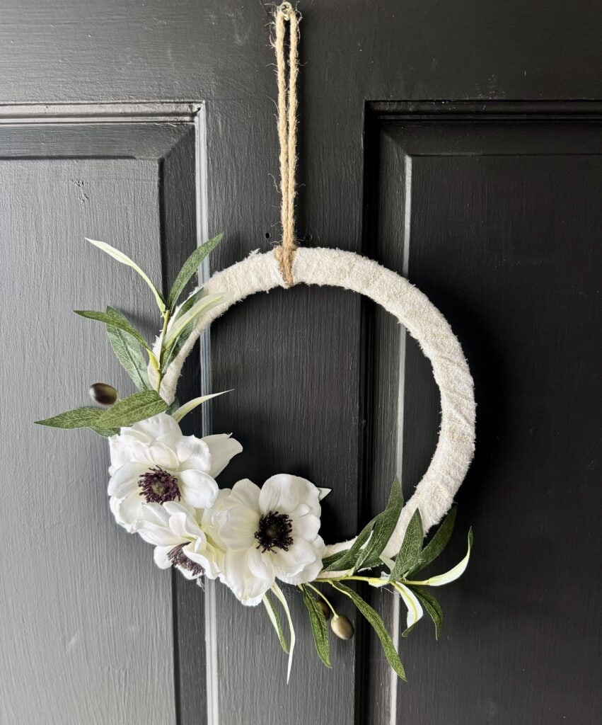 Whimsical floral wreath door decoration with white anemones and greenery, perfect for farmhouse style, handmade home decor, or spring and summer embellishments for your entryway.
