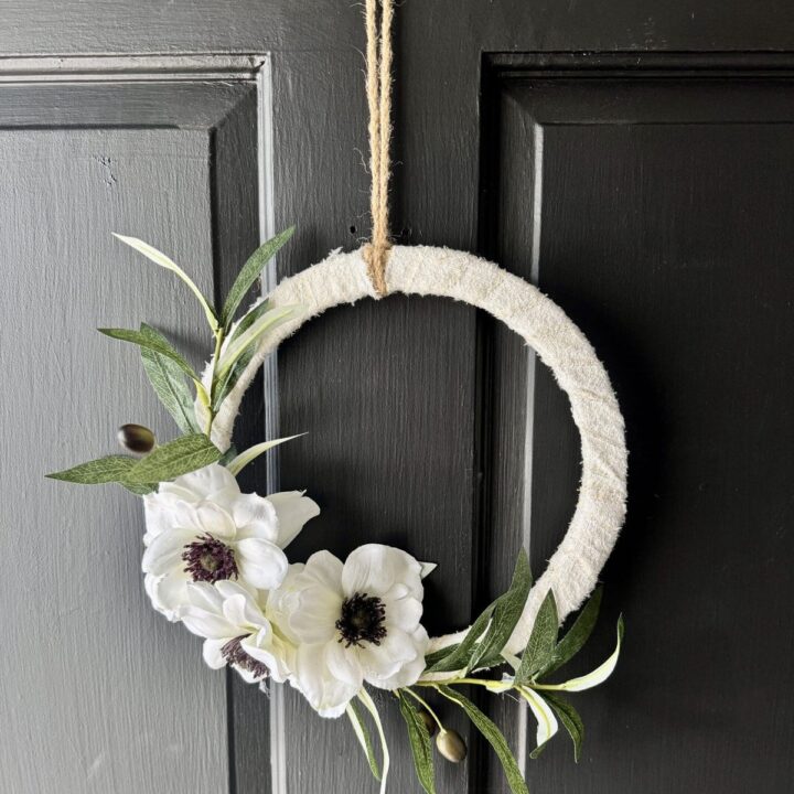 Whimsical floral wreath door decoration with white anemones and greenery, perfect for farmhouse style, handmade home decor, or spring and summer embellishments for your entryway.