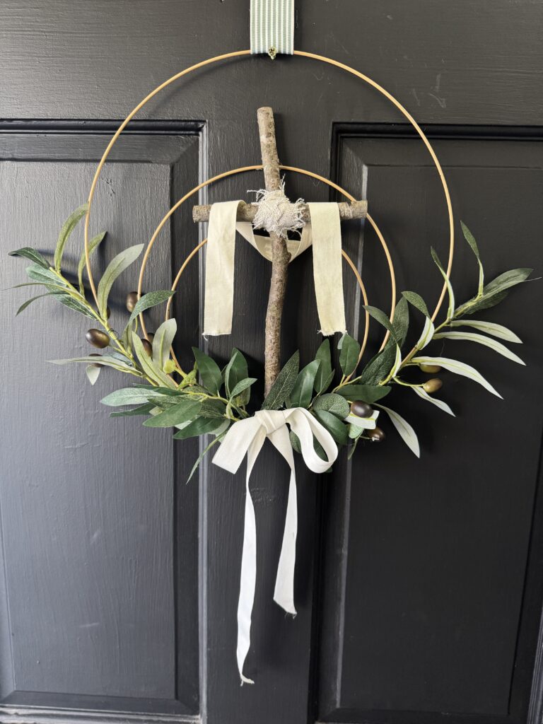 ribbon on top of easter cross wreath hanging on door
