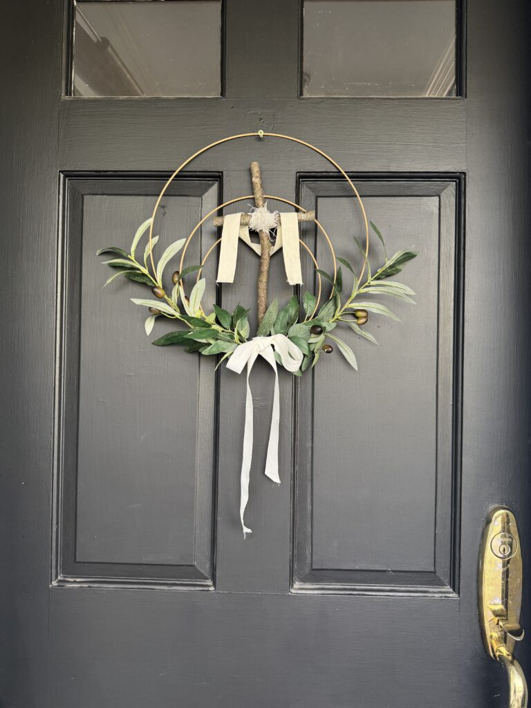 cross easter wreath hung on screw on door