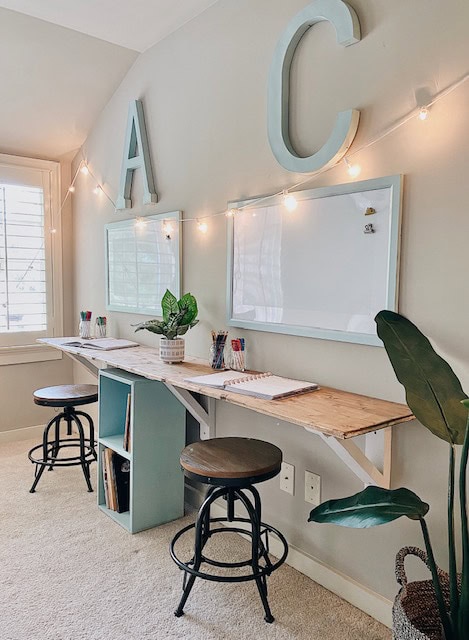 "A Hundred Affections" workspace with large decorative letters on the wall, whiteboards, and cozy seating area, creating an inspiring environment for productivity and creativity.