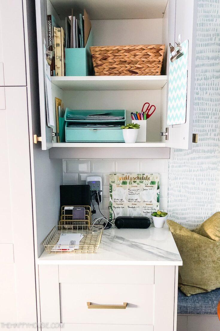 Organized home office desk with stacks of files, stationery, and decorative plants for productivity and cozy decor.
