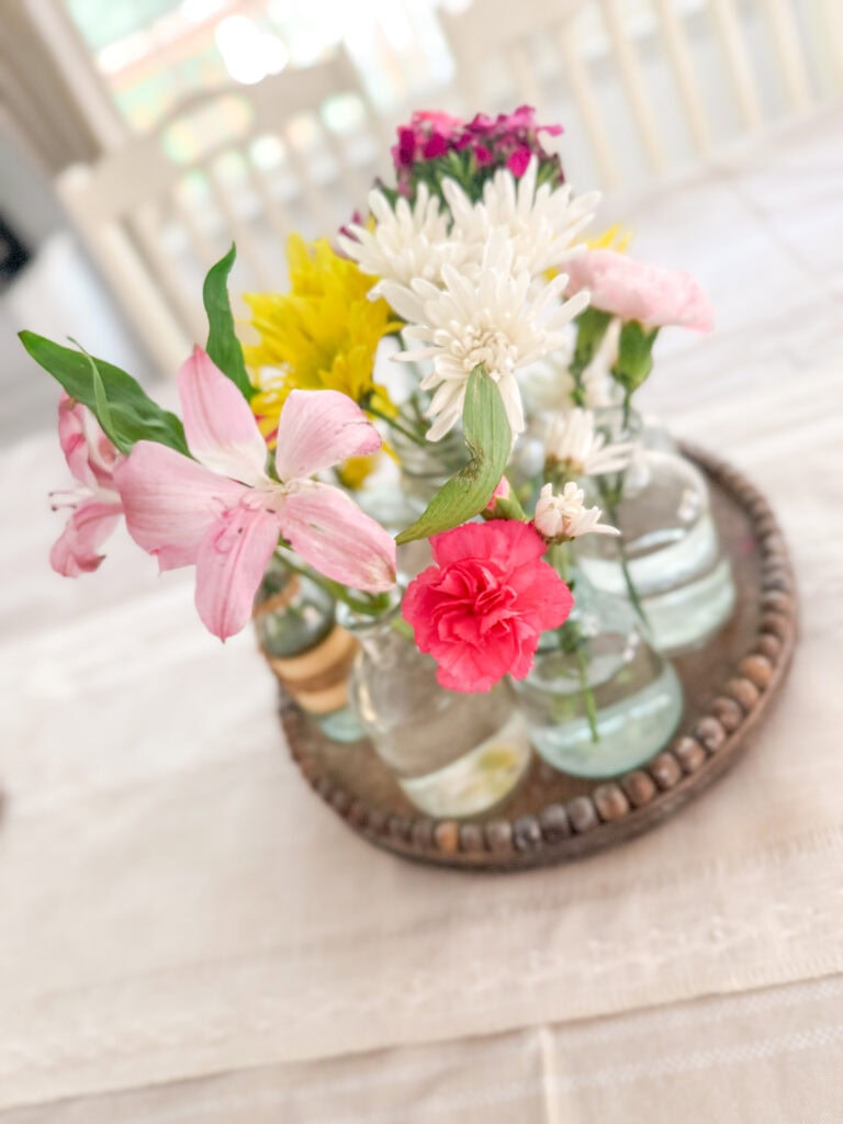 summer centerpiece with color blooms in tray