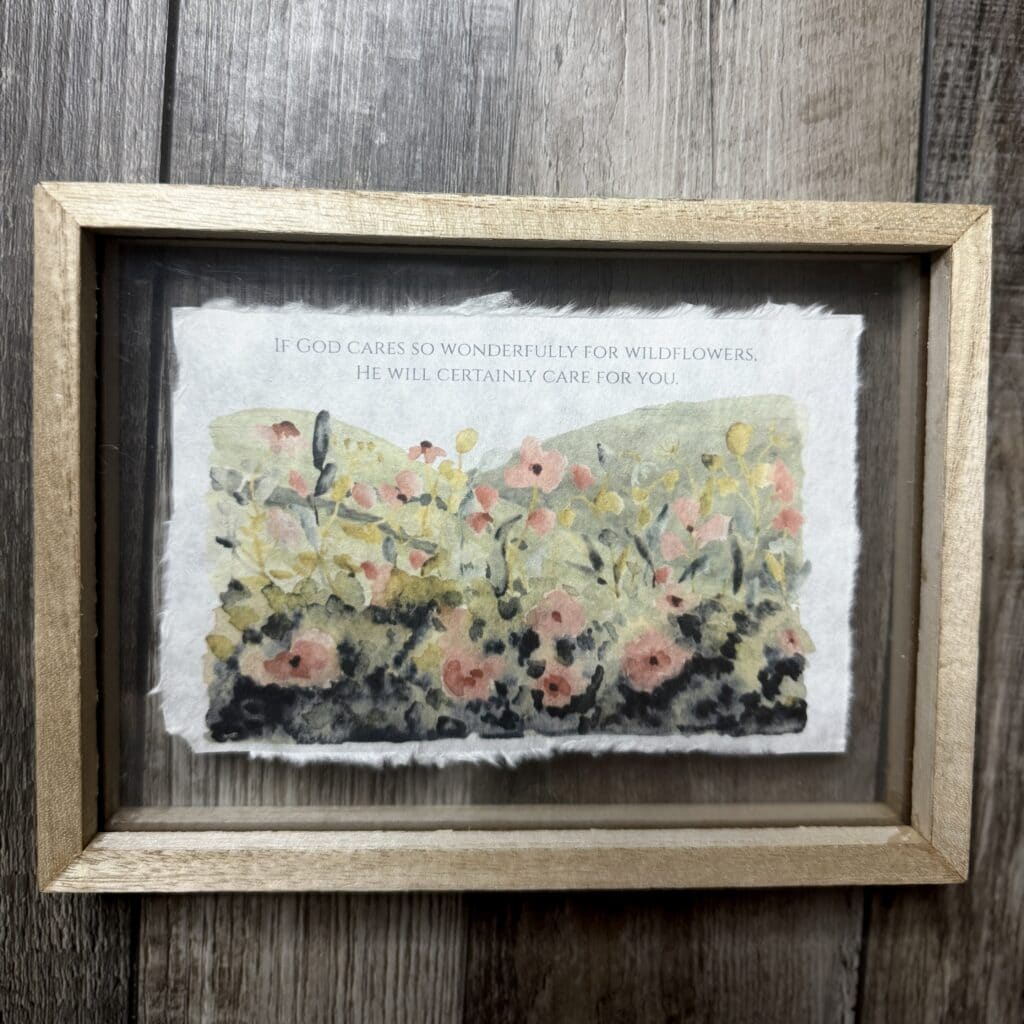 Vivid watercolor print of wildflowers with a heartfelt quote about God's care for nature and us, framed in rustic wood, perfect for inspirational home decor and spiritual inspiration.