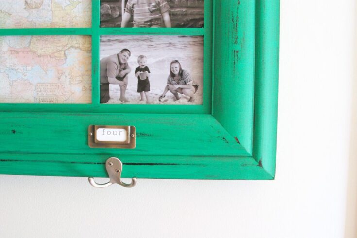 Colorful vintage-inspired photo display with family photos, featuring a bright turquoise frame, a label with the number "four," and a wall hook, perfect for personalized home decor and family memories.