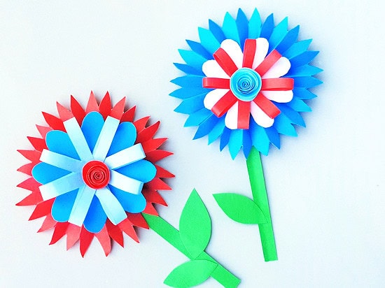 A colorful patriotic paper flower craft featuring red, white, and blue petals with green stems and leaves, perfect for Independence Day celebrations or festive decor.