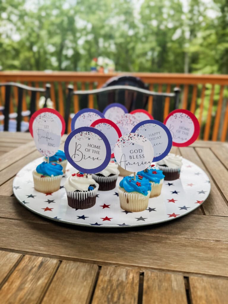 white plate with blue and red stars with cupcakes on top and patriotic toppers