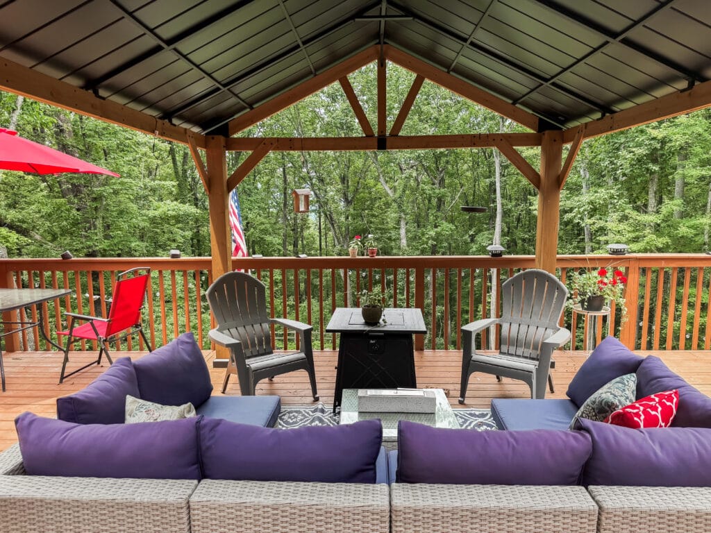 fire pit table and chairs with sectional under gazebo on deck