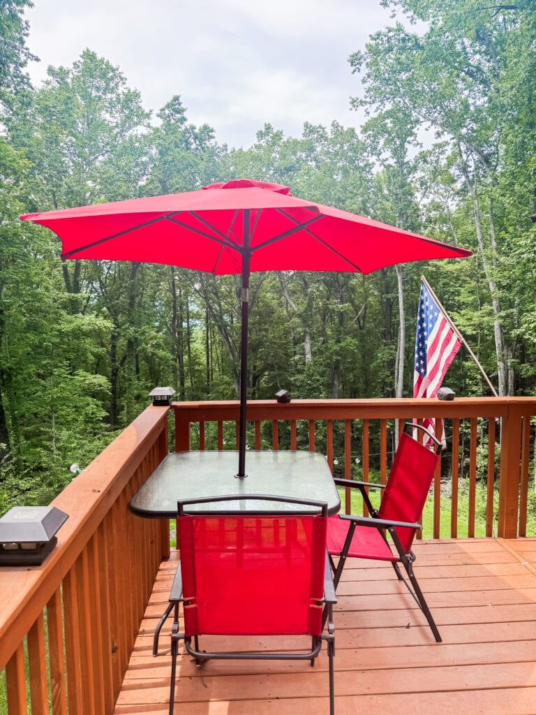 red chairs and umbrella on deck
