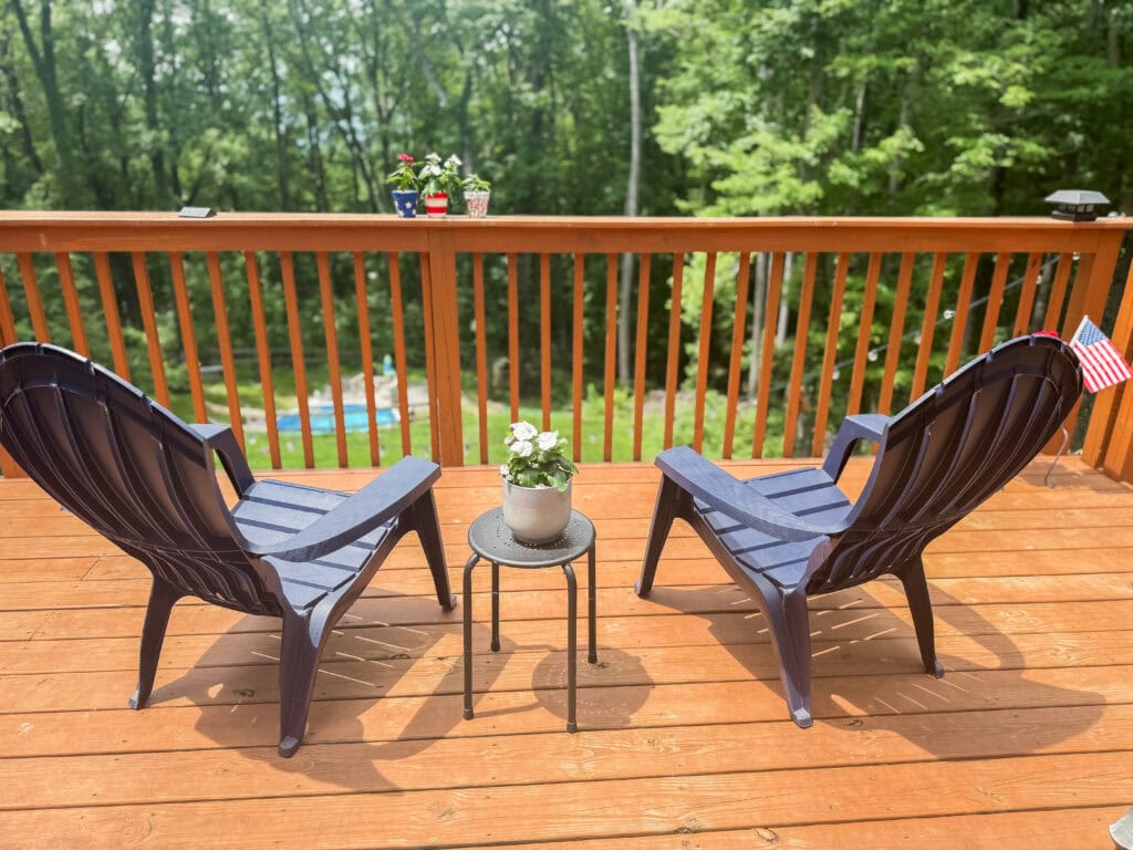 blue adirondack chairs facing mountains on 4th of july deck