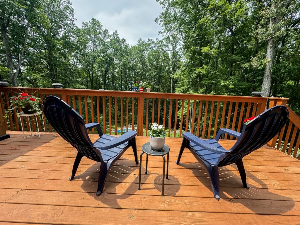 blue adirondack chairs facing mountains on 4th of july deck