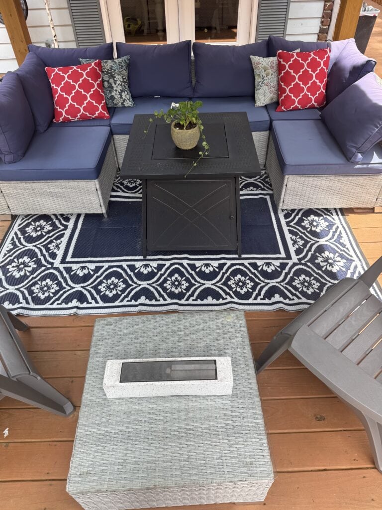 Blue sectional with red pillows under gazebo