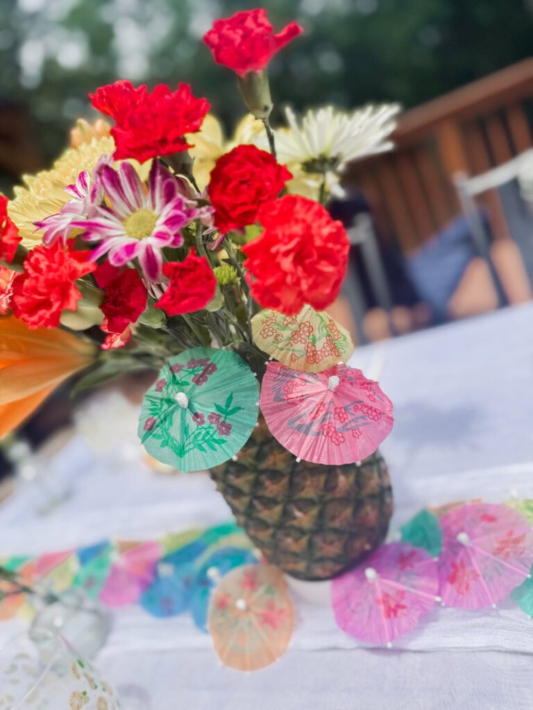 paper umbrellas on pineapple floral centerpiece