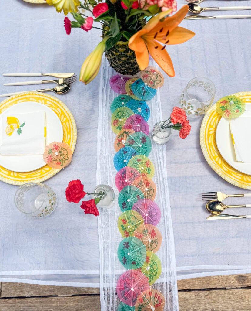 bud vases with flowers along table runner for summer tablescape