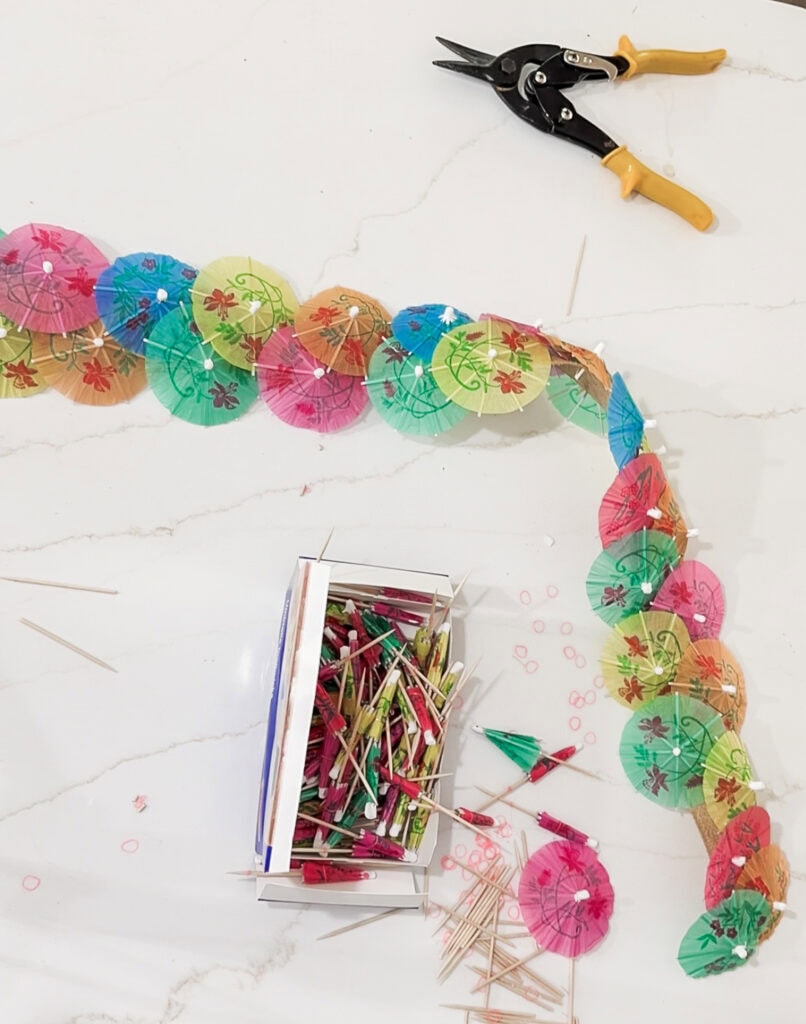 Colorful paper umbrellas and skewers in a craft project, vibrant decorations for a celebration, creating a festive and cheerful atmosphere.