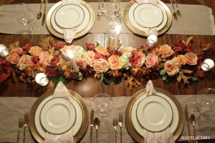 Elegant table setting with floral centerpiece, gold-rimmed plates, and candlelit ambiance for wedding or special occasion dining.