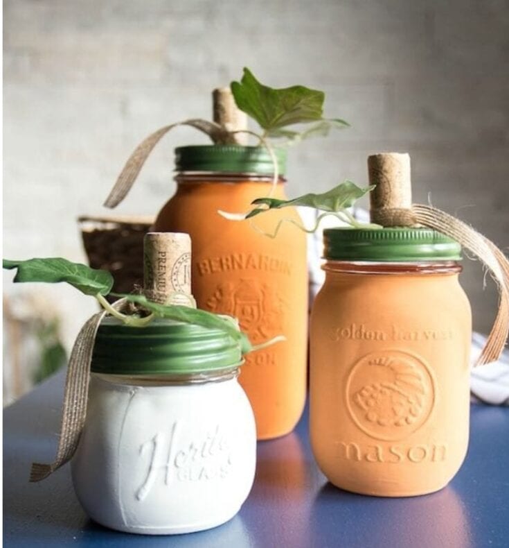 Handmade painted Mason jars with greenery and twine accents, perfect for home decor and gifting, by A Hundred Affections.
