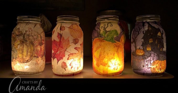 Handmade fall-themed mason jar lanterns with autumn leaves, pumpkins, and spooky Halloween designs, perfect for cozy seasonal decor and festive ambiance.