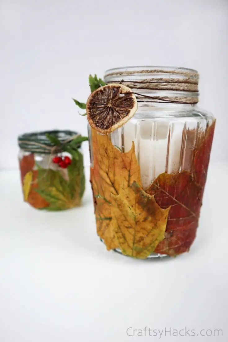 Sweater weather mason jar candle and leaf decor perfect for fall ambiance.