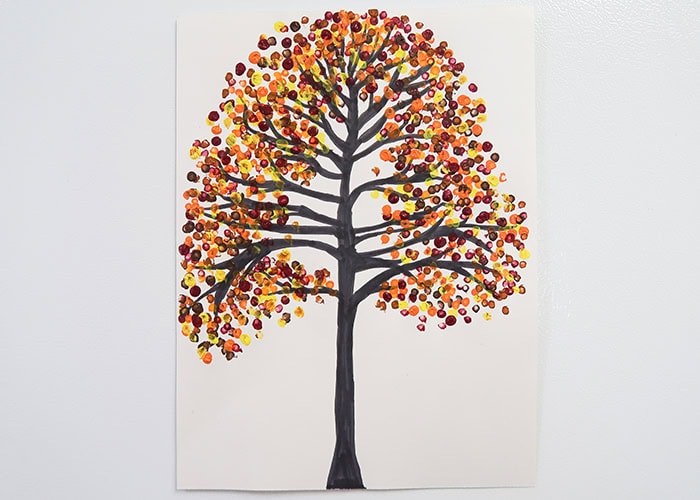 Vibrant autumn tree painting with colorful leaves in warm tones, featuring black branches on a white background. Perfect for fall decor and nature-inspired artwork.