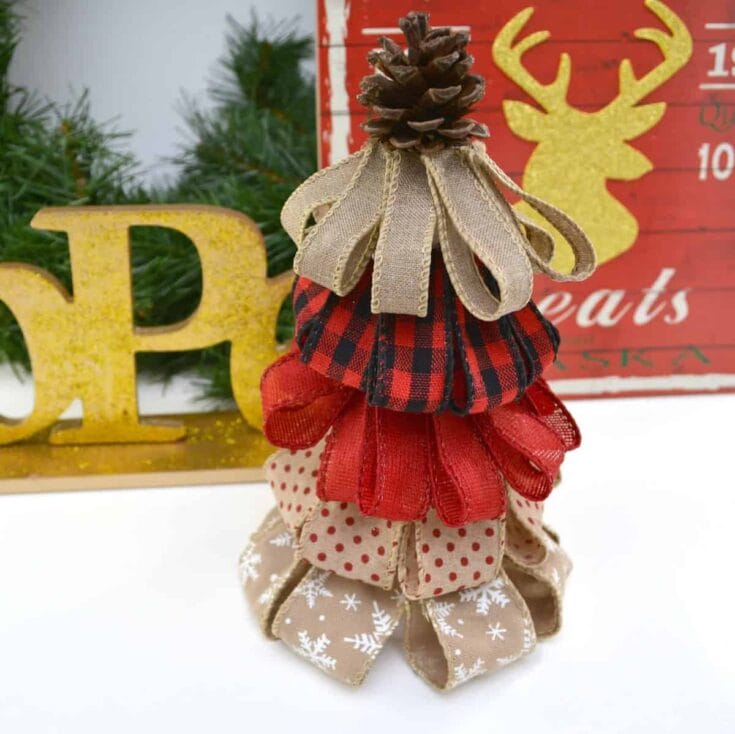 Christmas fabric tree ornament with pinecone top, featuring red, beige, and polka dot fabrics, perfect for holiday decor and festive home accents.