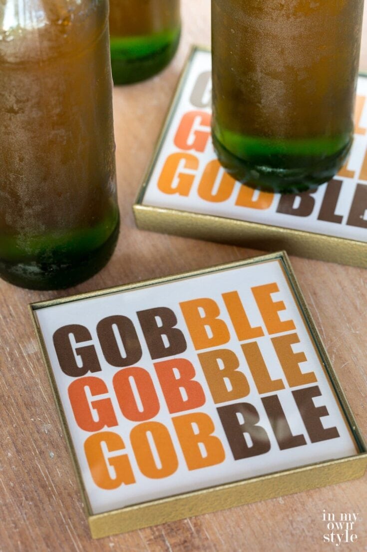 Bright green glass soda bottles on wooden table with "GOBBLE" themed snack or game items, ideal for festive gatherings and cozy holiday celebrations.