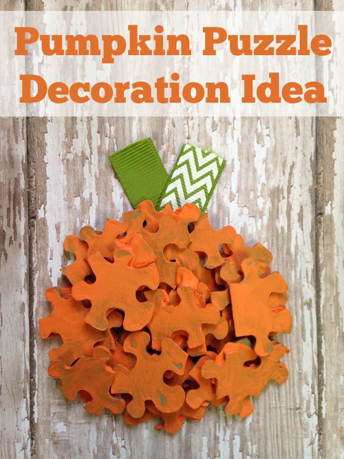 Colorful pumpkin puzzle decoration craft for fall and Halloween DIY home decor, featuring foam puzzle pieces in orange with green accents, perfect for seasonal Halloween and autumn decorating.