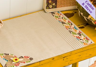 White embroidered table runner with colorful floral and leaf border, handmade home decor, A Hundred Affections.