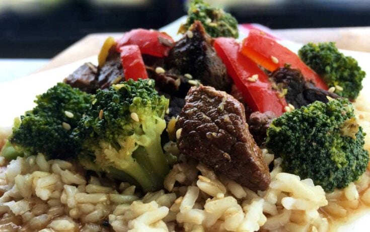 Sautéed beef bites with broccoli and red bell peppers served over brown rice, highlighting healthy, flavorful meal options from A Hundred Affections.