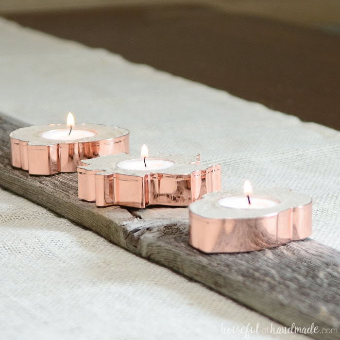 Rose gold tea light candles on rustic wooden plank for romantic or cozy home decor, perfect for creating warm ambient lighting. Ideal for weddings, special occasions, or relaxing evenings.