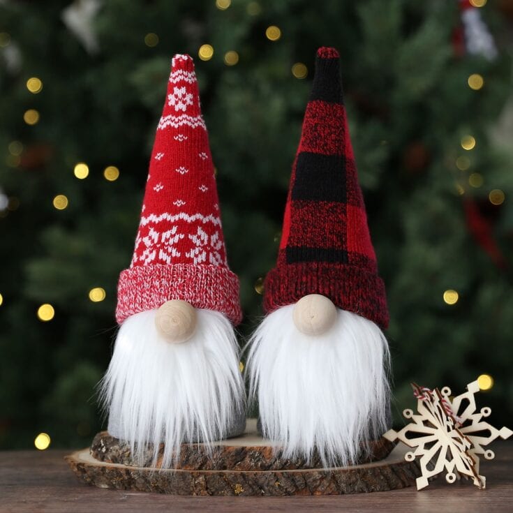 Gnome Christmas decorations wearing cozy knit hats, holiday decor for Christmas, festive gnome figures with long white beards, holiday table display with wood slice base, seasonal Christmas ornament snowflake, cheerful holiday home decor for winter celebrations.