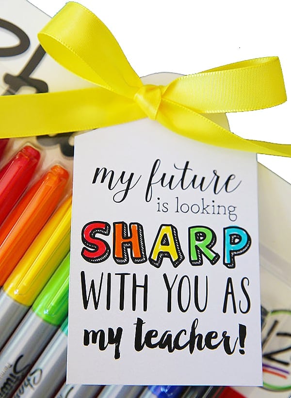 Bright yellow ribbon tied in a bow with colorful markers and a motivational teacher gift card, perfect for teacher appreciation, back-to-school, or educational novelty gifts.