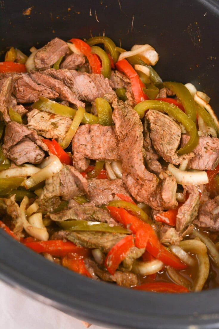 Sliced beef with colorful bell peppers cooking in a slow cooker, healthy dinner recipe, easy beef stew, crockpot meal, home-cooked comfort food, nutritious beef and vegetable dish, flavorful slow cooker recipes.