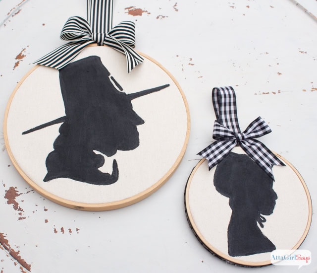 Silhouette embroidery hoop art of Harry Potter and Luna Lovegood with black and white plaid bows, perfect for Harry Potter fan decor and handmade gift ideas.