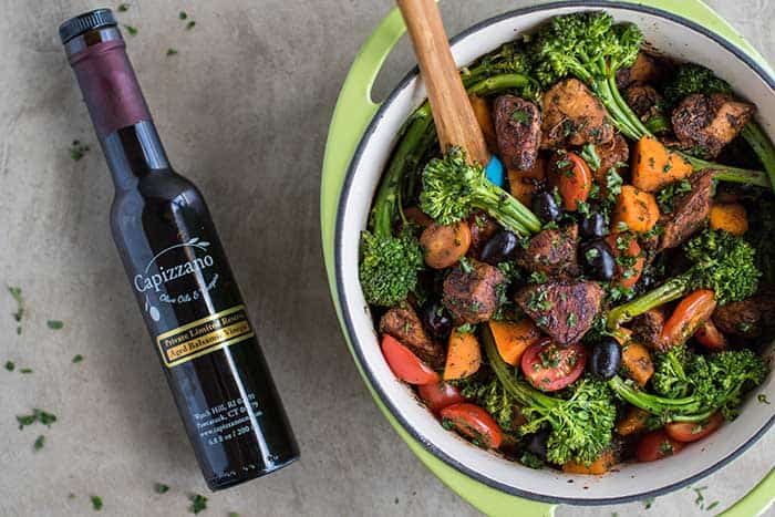 Vibrant vegetable beef stew in a green pot with broccoli, carrots, cherry tomatoes, and herbs, served as a healthy, hearty meal. Perfect for nutritious family dinners or meal prep.