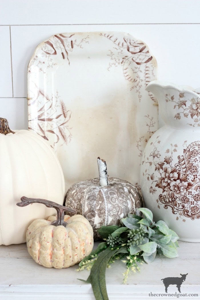 Cream and beige decorative pumpkin, vintage floral accents, and greenery arrangement for rustic fall decor, inspired by farmhouse and autumn aesthetic.