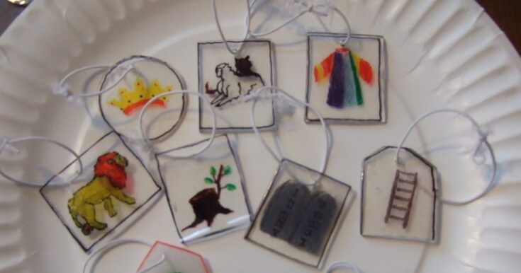 Colorful handmade tie-dye and embroidered charms featuring a lion, horse, crown, ladder, and tree, arranged on a white tray, representing creativity and personalized accessories from A Hundred Affections.