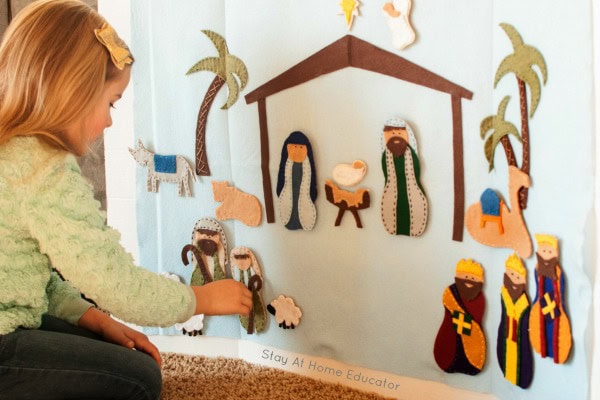 Colorful felt nativity scene wall decoration with figurines of Mary, Joseph, baby Jesus, Wise Men, and animals, perfect for Christmas decor and enhancing children's religious education.