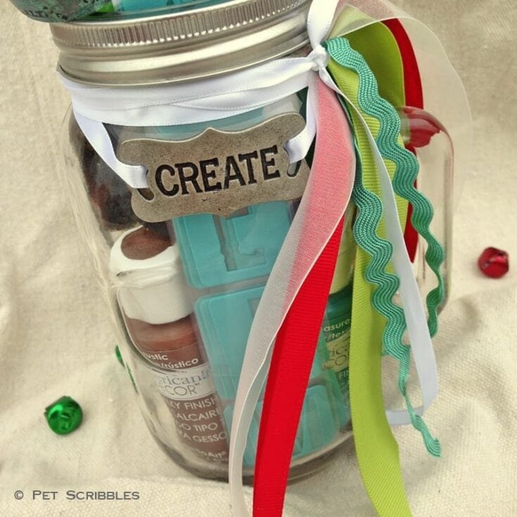 Acrylic paint jar with colorful ribbons and a "Create" tag for arts and crafts projects.