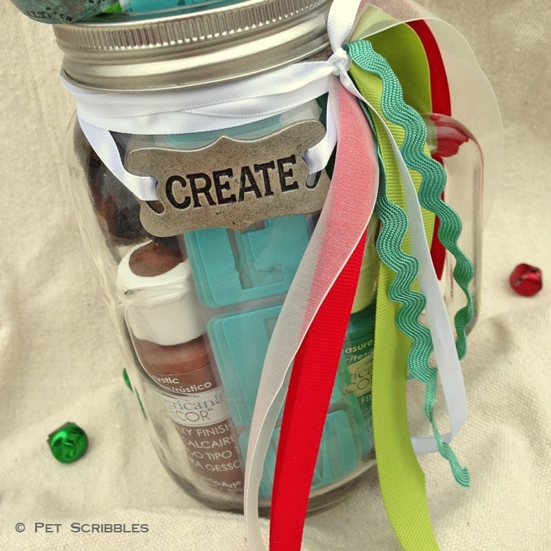 Acrylic paint jar with colorful ribbons and a "Create" tag for arts and crafts projects.
